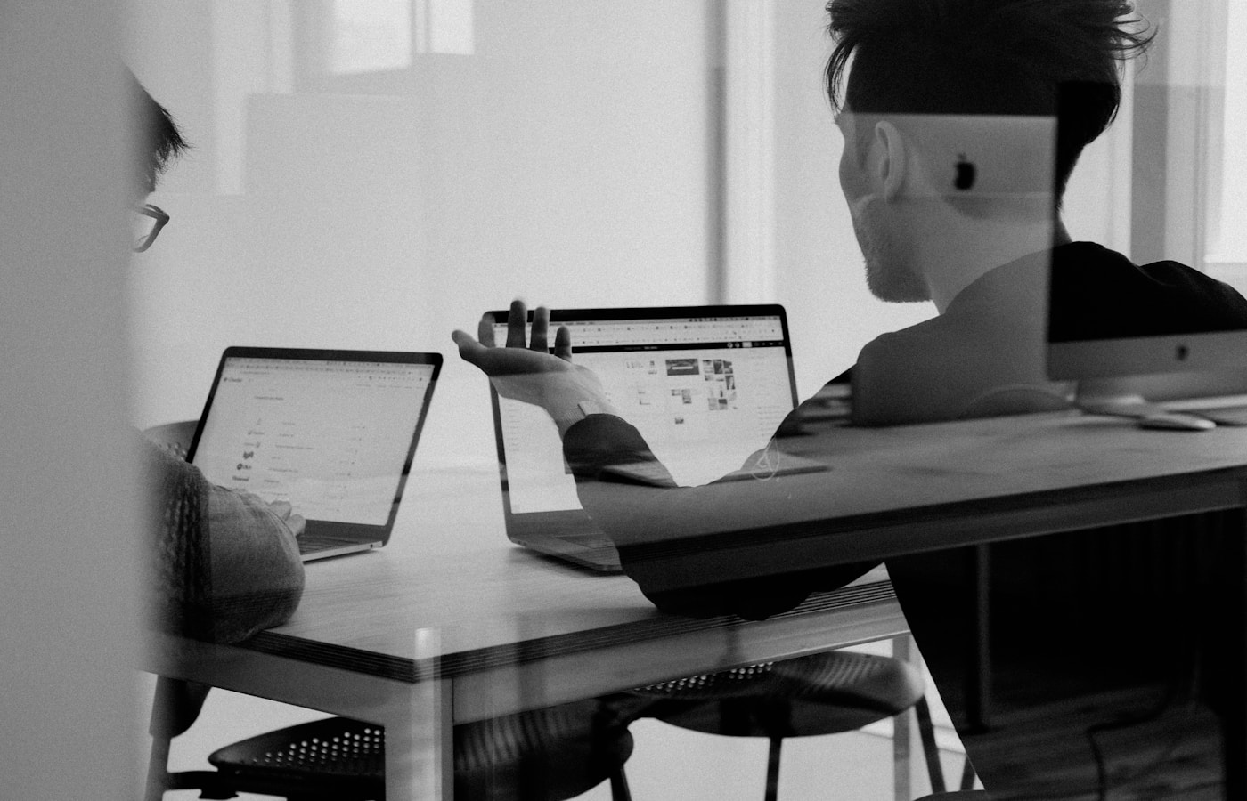 Marketing team reviewing campaign analytics on a large screen
